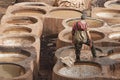 FEZ, MOROCCO Ã¢â¬â FEBRUARY 20, 2017 : Man working at the famous Chouara Tannery in the medina of Fez, Morocco Royalty Free Stock Photo
